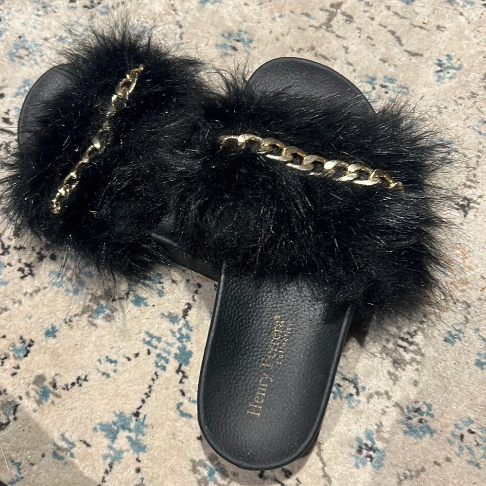 Black fuzzy slides with gold chain detail